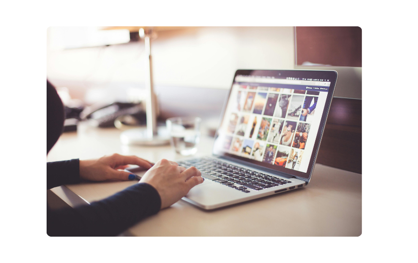 Person browsing images on a laptop, representing how to start an online business and build a brand through visual content.